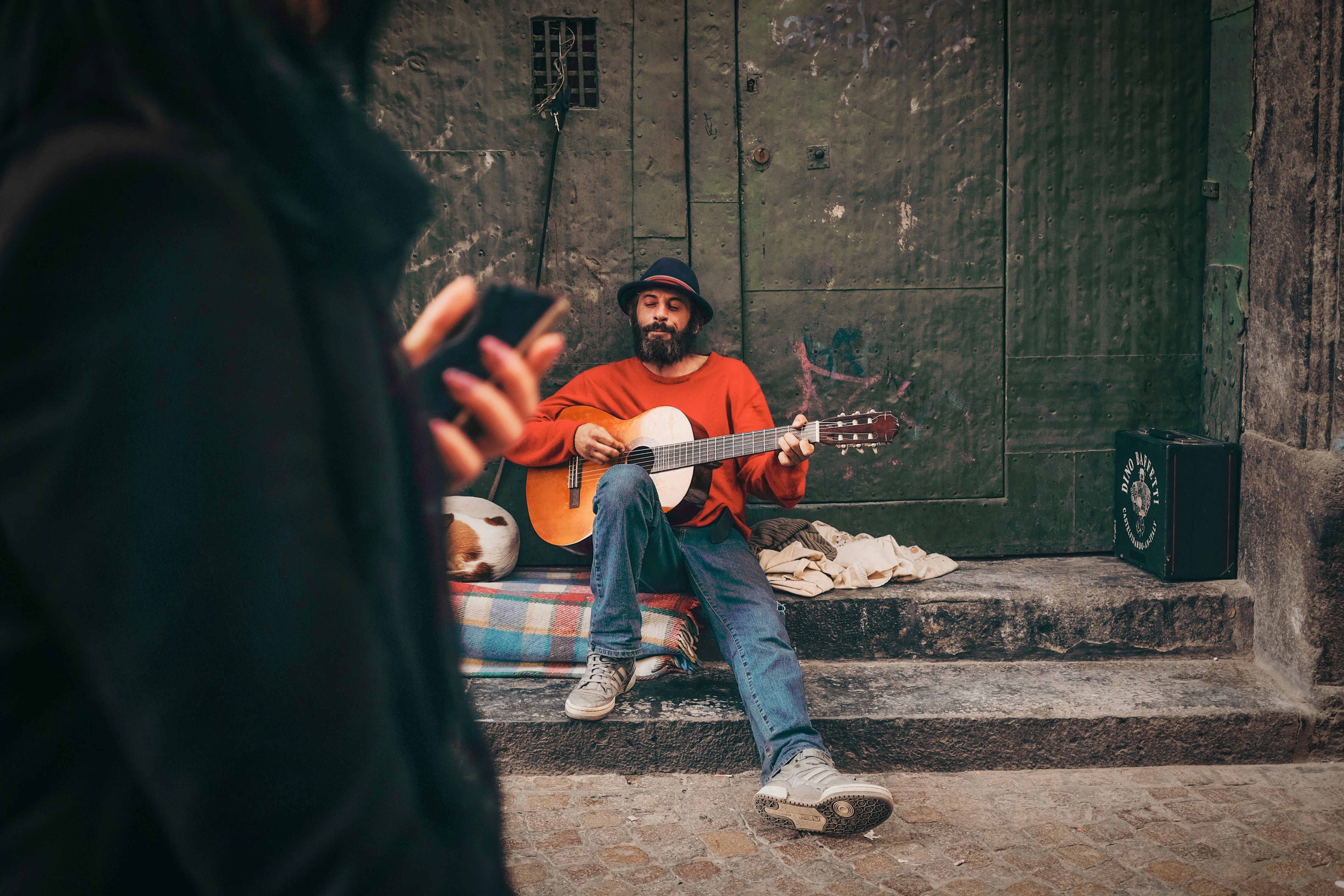 man holding orange guitar